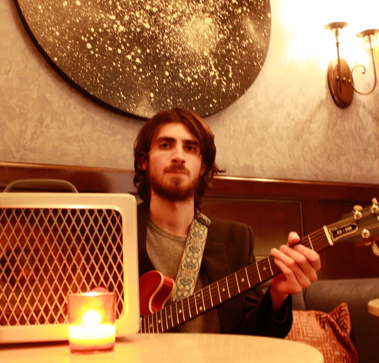 Warren Galea playing guitar in an intimate indoor setting
