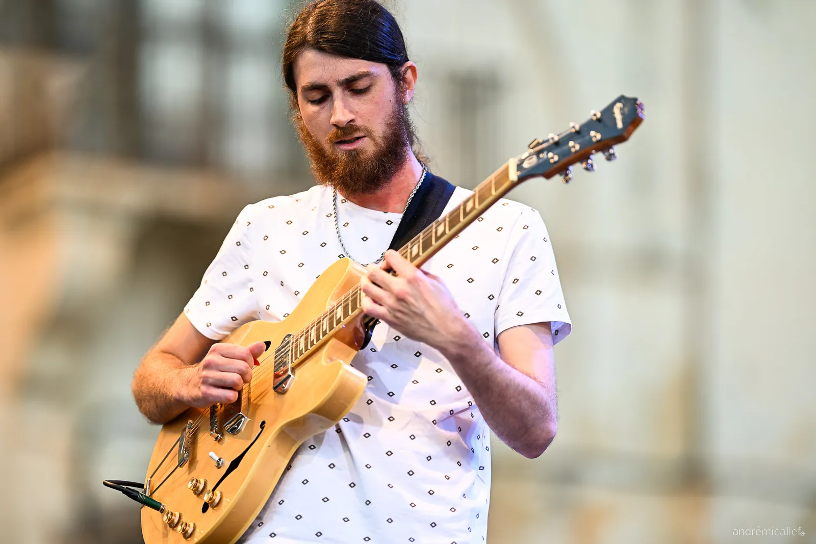 Warren Galea playing guitar at an outdoor jazz performance