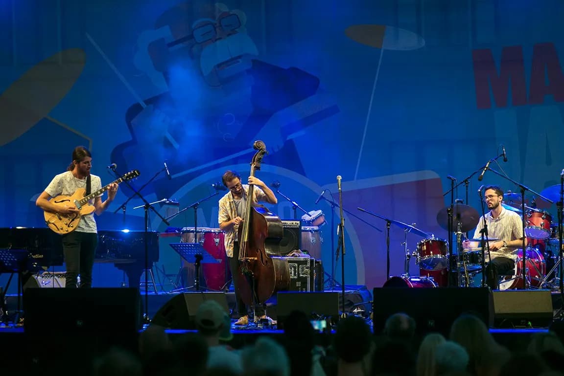 Warren Galea performing with an ensemble on a festival stage